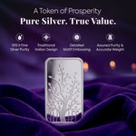 Silver bar with tree design on a purple fabric background, featuring text about purity and value.
